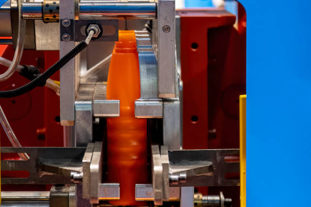 istock The orange bottle container manufacturing process by blow mold machine. 1413367581