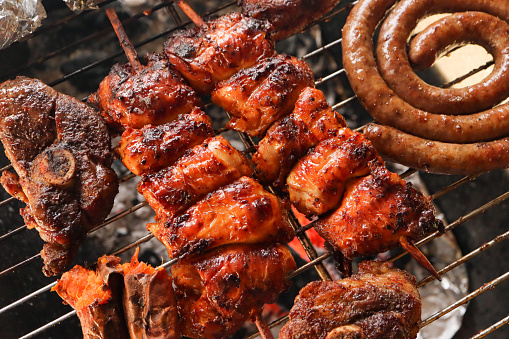 Braai meat including boerewors sausage, lamb chops and chicken kebabs. Chicken espetadas