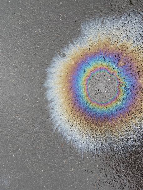 istock Eco concept, oil spill on asphalt road close up 1413368749