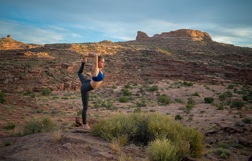 Yoga Lord of the Dance posture at sunset in Moab, Utah