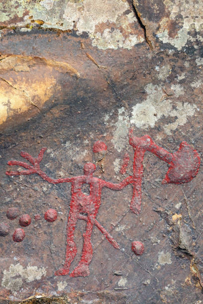 istock Axe man rock carving on a cliff 1413371830