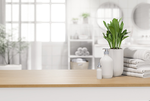 Empty wooden table top for copy space with blurry bathroom background 3d render