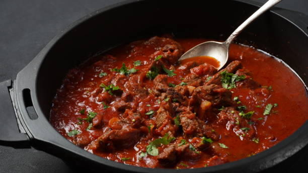 istock Beef stew with tomato sauce, spices and herbs in a pan 1413382182