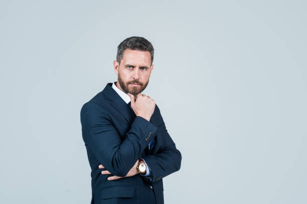 istock handsome smiling bearded businessman in suit, copy space, ceo 1413382612