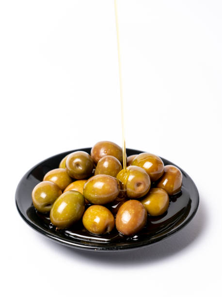 delicious salted olives with olive oil on a black plate stock photo