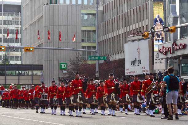 Pipe band featured in the (Calgary) Stampede Parade coming through downtown. The parade marks the start of the Calgary Stampede rodeo festival. Taken in July 2017.