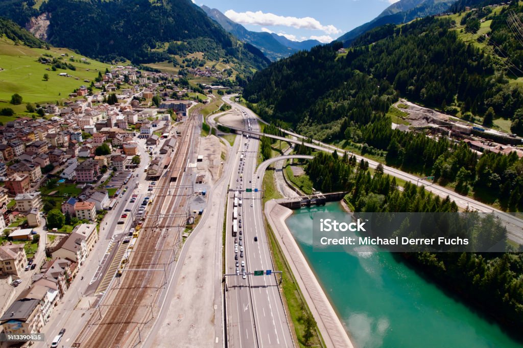 Aerial view of mountain village Airolo, Canton Ticino, with Gotthard highway and Ticino River on a blue cloudy summer day. Photo taken June 25th, 2022, Gotthard Pass, Switzerland. Airolo Stock Photo