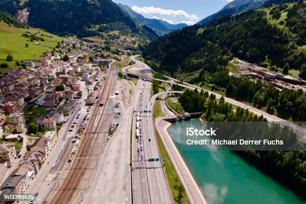 Aerial View Of Mountain Village Airolo Canton Ticino With Gotthard Highway And Ticino River On A Blue Cloudy Summer Day Stock Photo - Download Image Now