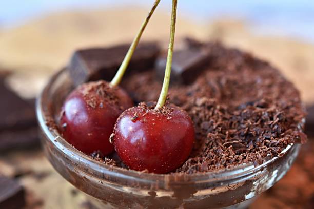 istock red cherry in chocolate chips and dark chocolate pieces. dessert 1413392356