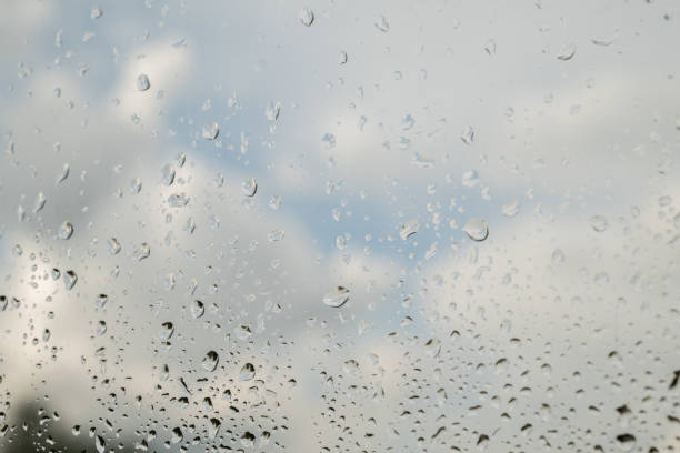 istock Rain drops on the glass. Beautiful blue and white sky. Sky background 1413395446