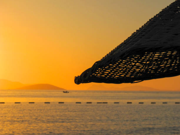 Dusk over the Sea with reed umbrella