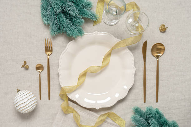istock Christmas table setting with golden cutlery and Christmas decorations. Top view, flat lay. Selective Focus 1413395787