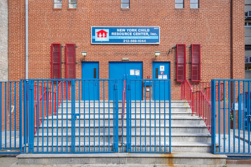 Northern Broadway, Manhattan, New York, NY, USA - June 28, 2022: Entrance to a private school with heavy gate and window blinds at the northern end of Broadway