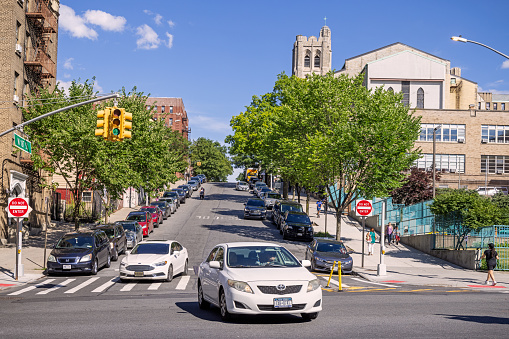 Northern Broadway, Manhattan, New York, NY, USA - June 28, 2022: Cars coming down West 187th Street, which is a one way street on a sunny summer day