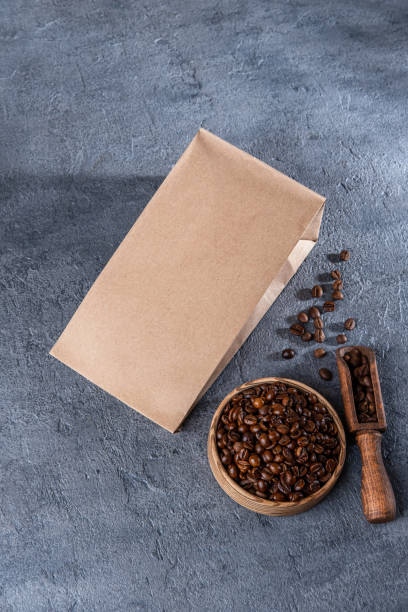 istock Coffee identity branding mockup. Blank brown craft bag with coffee beans. Package mockup template for logo, brand, sticker, label. Top view, flat lay 1413397982