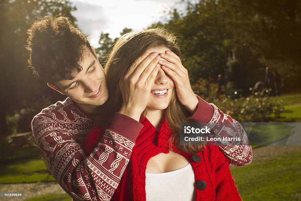 Man covering girlfriends eyes in park  Covering Stock Photo