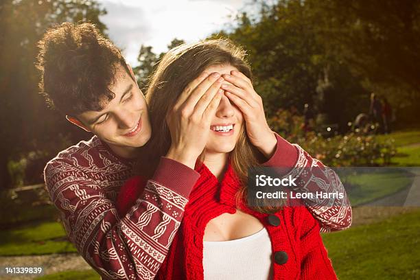 Man Covering Girlfriends Eyes In Park Stock Photo - Download Image Now - Covering, Eye, Women