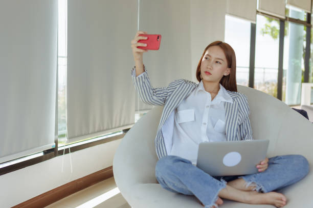 istock learnning online,social network comunication,woman sitting at the table in the work space with cell phone 1413399188