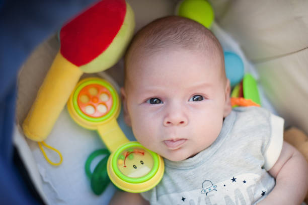 istock Funny baby boy is talking and using toy telephone headset 1413404415