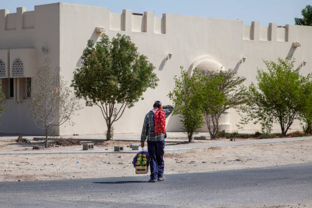 Man carrying his groceries home, after buying them on the wholesale Market in Doha Qatar, located off the Salwa Road on the way to Mamoura.