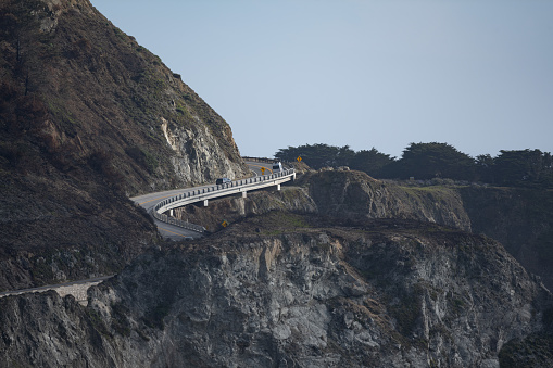 Cars driving on the pacific highway at the Big Sur coastline in California, USA.