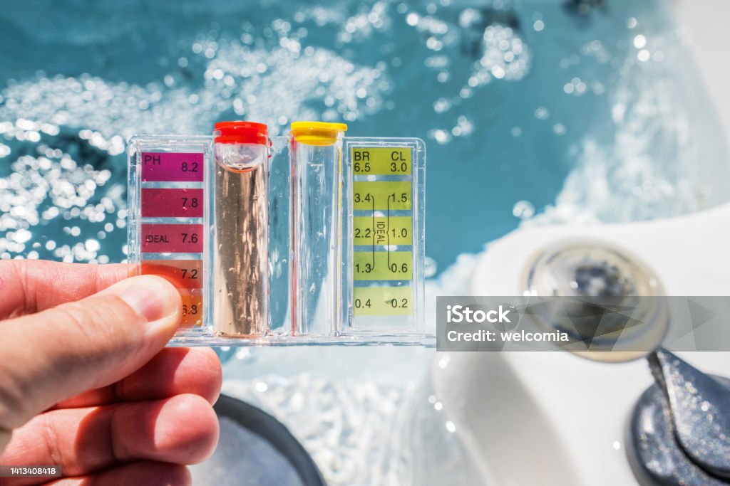 Hot Tub Water Quality Check by Using Chemical Testing Kit. Hot Tub Water Quality Check by Using Chemical Testing Kit. pH, Chlorine and Bromine Concentration. Garden SPA Water Maintenance. Hot Tub Stock Photo