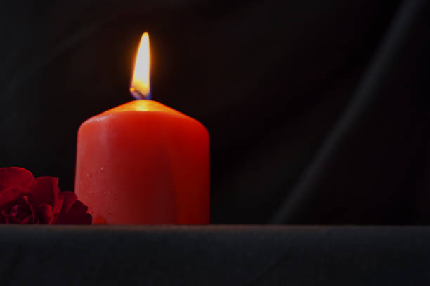 istock a red burning candle and a red rose on a black background copy space gothic style 1413411066