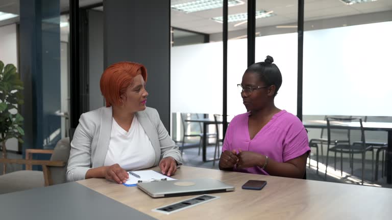 Women greet shaking hands and sit down to talk