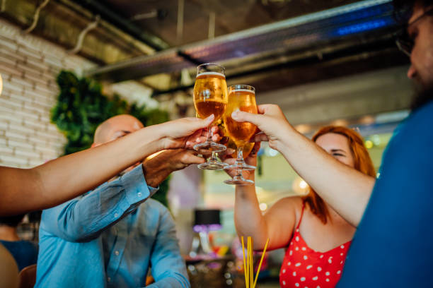 istock Young friends making a toast in the bar 1413414934