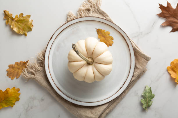 istock Overhead view of table setting with white pumpkin autumn 1413415002