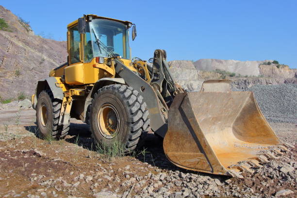 istock a yellow loader (tractor) in the middle of a stone quarry 1413416919