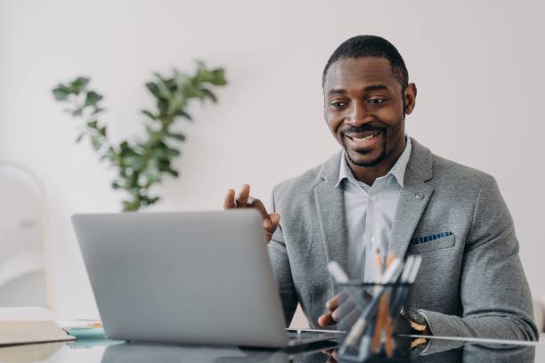istock Young man has video conference on laptop. Freelancer is working online at workplace at home. 1413417618