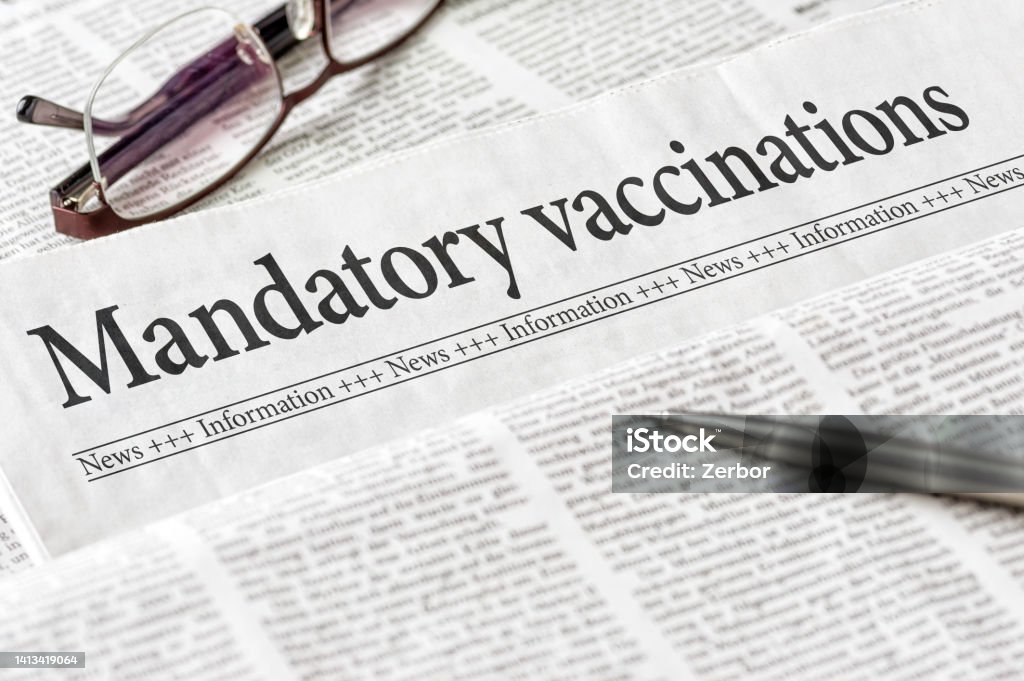 A newspaper with the headline Mandatory vaccination Article Stock Photo