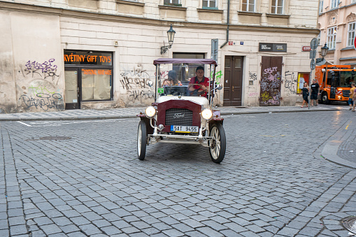Prague - April 25, 2017: A retro car on the street in Prague. Cars are used for tourist excursions in Prague. Driver is driving tourists through an old center of Prague