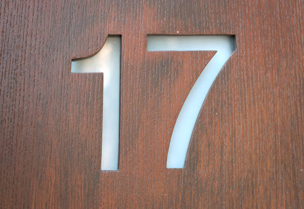 istock Number seventeen on wood background 1413420765