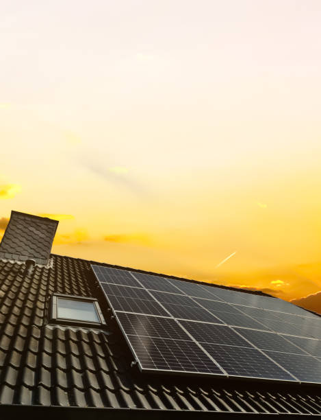 solar panels producing clean energy on a roof of a residential house - window sun sunlight vertical imagens e fotografias de stock