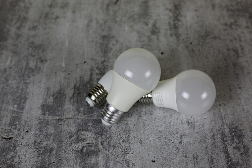 Diode light bulbs on a white background. Light bulbs of different shapes lie on the table