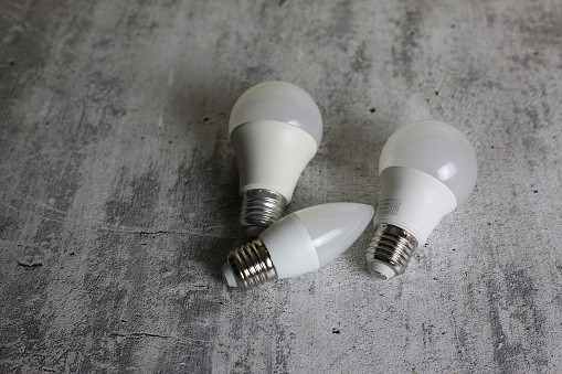 Diode light bulbs on a white background. Light bulbs of different shapes lie on the table