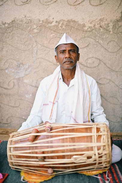 istock Rural Senior man playing Mrudung, a musical instrument 1413428982