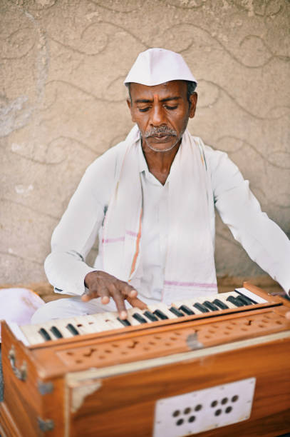 istock A Senior man from rural India playing harmonium, a musical instrument 1413429103