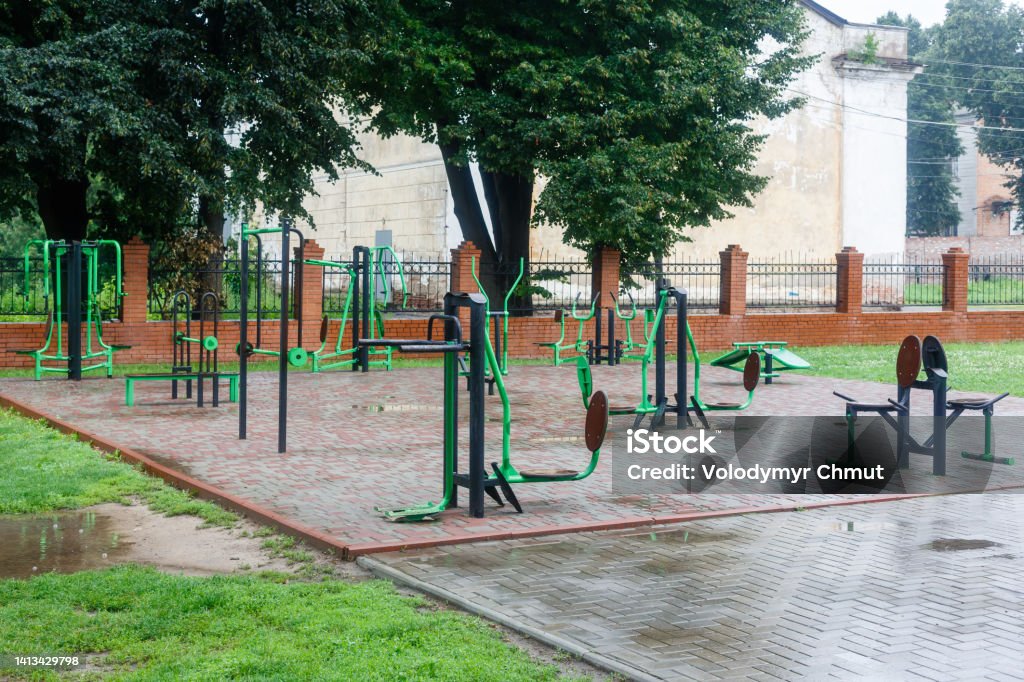Exercise stations in the public park. Free outdoor gym. Outdoor gym on the sports field in the park Exercise stations in the public park. Free outdoor gym. Outdoor gym on the sports field in the park. Active Lifestyle Stock Photo