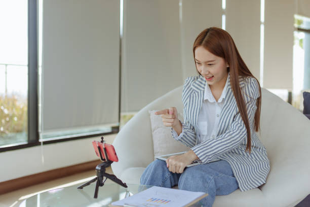 istock learnning online,social network comunication,woman sitting at the table in the work space with cell phone 1413430146