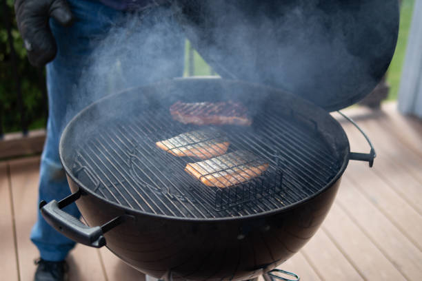 istock Backyard Home Barbecue Grill with Salmon and Steak Cooking 1413431456