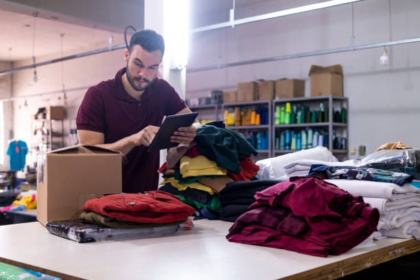 Young man in a clothes industry stock photo