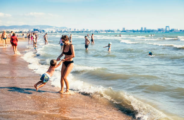 Woman playing with her son on the Anapa beach Anapa, Russia - June 25, 2022: A young mother plays with her child on the beach of the resort town of Anapa on a summer sunny day krasnodar krai stock pictures, royalty-free photos & images