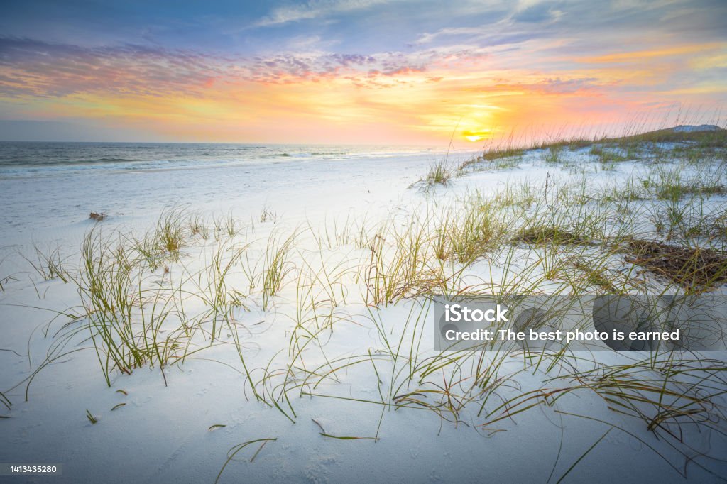 Peaceful View At The Gulf Islands National Seashore Florida From Navarre Beach to Pensacola is miles of paradise across this sensational seascape running from east to west. This stretch of brilliant bright white scenery is highlighted by the dunes and is also protected as part of the Gulf Islands National Seashore. Okaloosa Island is a narrow three-mile island between the cities of Fort Walton Beach and Destin, Florida. Beach Stock Photo