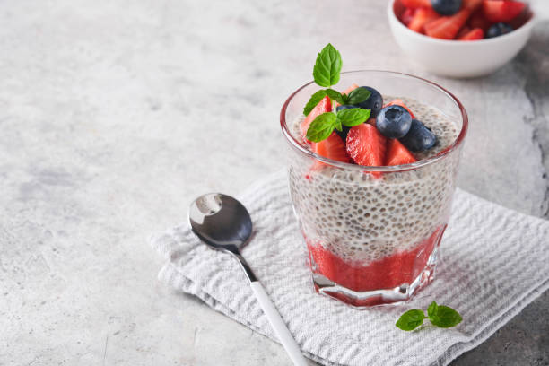 istock Chia strawberry pudding. Healthy vegan breakfast chia seeds pudding with fresh berries and mint in glass on gray concrete background. Concept of healthy eating, dieting, fitness menu. Selective focus. 1413436004
