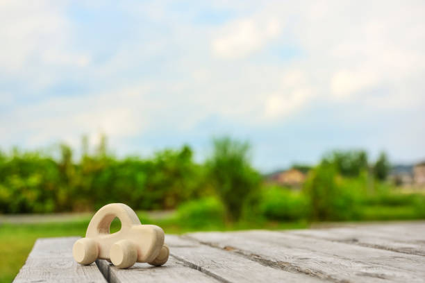 Wooden miniature car, outdoor natural background.