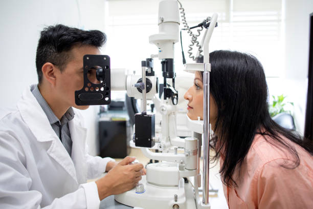 istock oculist examining female patient 1413438646