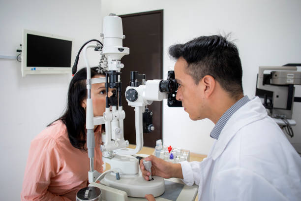 istock oculist examining female patient 1413438649